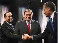 Mike Huckabee and Mitt Romney shake hands before a debate, while Duncan Hunter looks on 
Click image to expand.