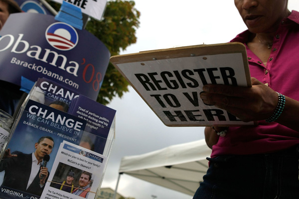 An Obama campaign volunteer helps to register voters in Virginia.