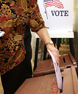 A woman casts her vote.
