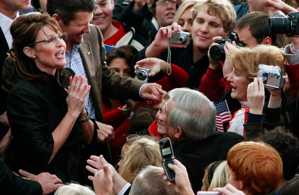 Sarah Palin and her husband, Todd, greet supporters at a campaign stop in Leesburg, Va.