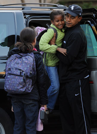 Malia, Sasha, and Barack Obama.