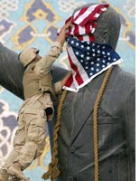A Marine drapes the flag over a statue of Saddam Hussein. Click image to expand.