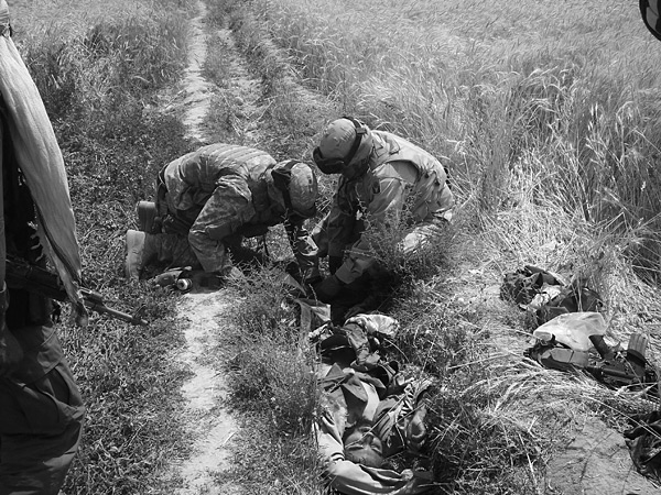 U.S. soldiers tend to a dying Taliban fighter.