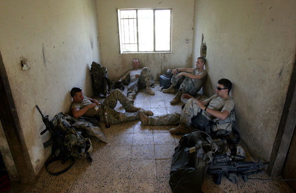 U.S. soldiers rest in a temporarily occupied Iraqi home.