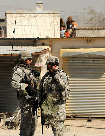 U.S. soldiers stand guard at the site of a suicide attack in Kabul.