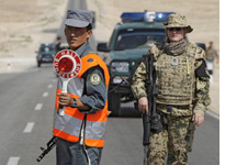 A NATO soldier trains an Afghani police officer. Click image to expand. 