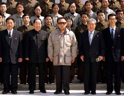Kim Jong Il posing with staff of the General Satellite Control and Command Centre. Click image to expand.