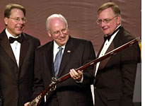 Dick Cheney examines a gun with NRA members
Click image to expand.