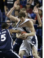 Xavier's Derrick Brown, left, grabs the jersey of Brigham Young's Trent Plaisted. Click image to expand.