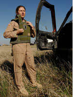 A pilot removes her bulletproof vest. Click image to expand.