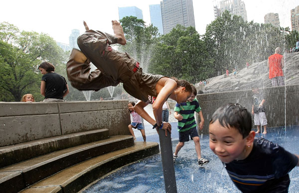 Kids play in a Central Park fountain in the summer.