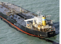 A damaged Hong Kong-registered tanker floats, spilling oil 
Click image to expand.