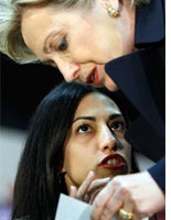 Hillary Clinton talks with a campaign staffer. Click image to expand.