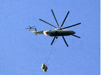 A helicopter drops relief supplies in Pakistan