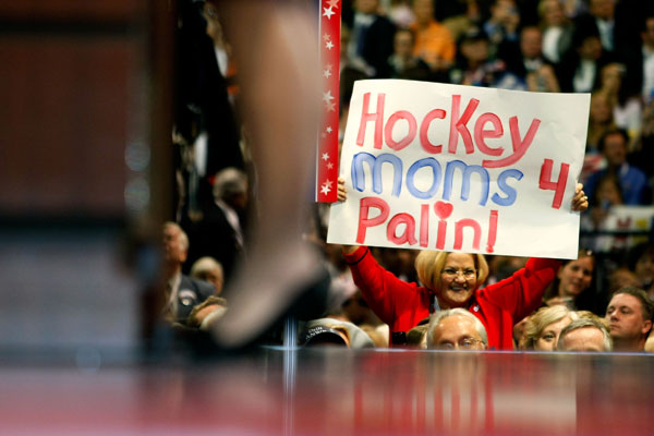 A Republican National Convention delegate holds up a "Hockey Moms for Palin" sign.