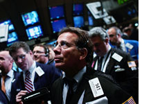 Traders work the floor at the beginning of the trading day at the New York Stock Exchange. Click image to expand.