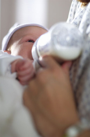 Baby drinking from a bottle.