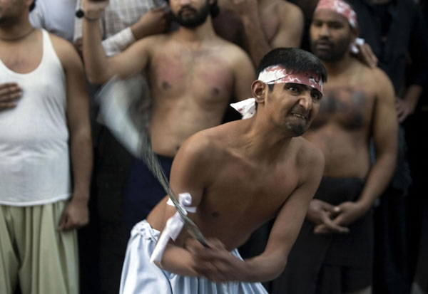 Pakistani Shiites flagellate themselves during a ritual held on the final day of the mourning period of Ashura.