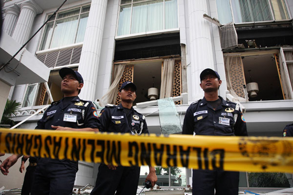 Police in front of bombed hotel in Jakarta, Indonesia.