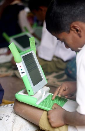 An Indian student works on a computer provided by One Laptop per Child.