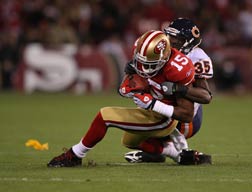Football players in tackle.