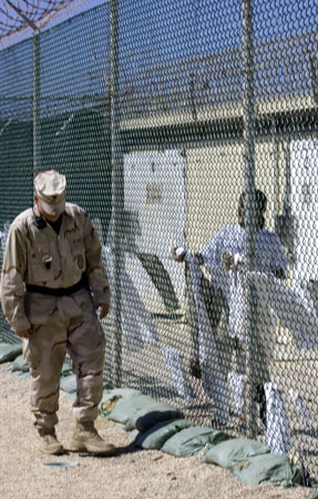 A guard and a detainee at Camp Delta in Guantanamo Bay.