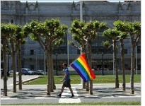 A man carries a gay pride flag through San Francisco's Civic Center Plaza. Click image to expand.