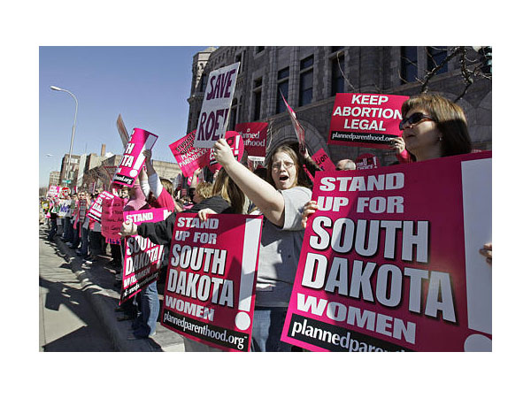 Demonstrators protest South Dakota's abortion laws.