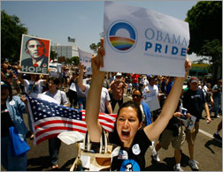Gay pride participants hold signs in support of Democratic presidential hopeful Barack Obama (D-IL) 