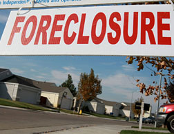 A sign in front of a foreclosed home.