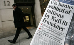 A copy of the London Evening Standard newapaper's front page is pictured against the entrance to the London office of Madoff Securities International in London. Click image to expand.