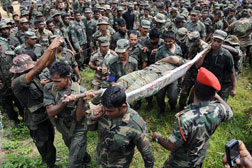 Sri Lankan soldiers carry the remains of what is said to be Tamil Tiger rebel leader Velupillai Prabhakaran. Click image to expand.