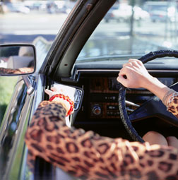 Woman driving with the car windows down.