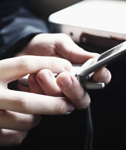 Person texting on a cell phone.