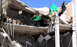 Libyans carry flags in the rubble of a university building in Tripoli. Click to expand image. 