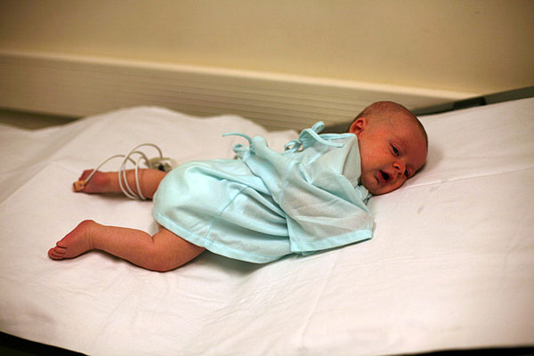 Walker with tubes in his left foot and wires taped to his chest.