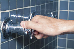 Hot shower knob being turned on.