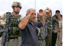U.S. soldier frisks an Iraqi man 
Click image to expand.