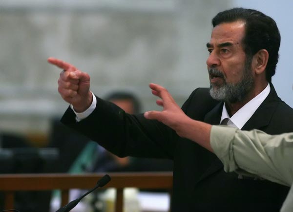 Saddam Hussein yells at the court.