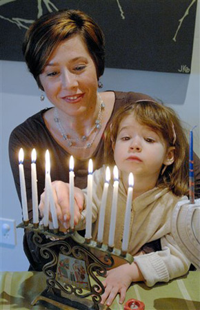 Lighting the menorah at Hanukkah.