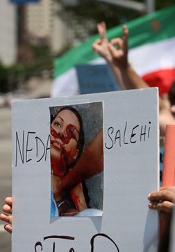 Protester holding sign with Neda on it.