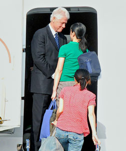 Bill Clinton with Laura Ling (in green) and Euna Lee (in red). Click image to expand.