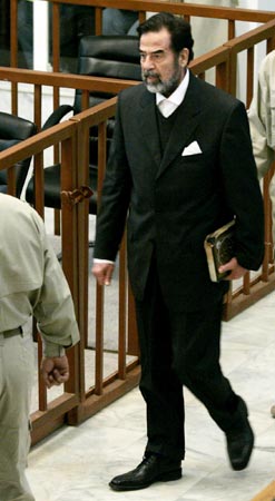 Saddam Hussein in suit, minus tie.