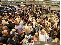 Passengers wait at Heathrow Airport. Click image to expand.