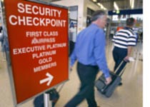 Photograph of airport travelers by Tim Boyle/Getty Images.