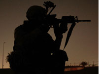 A soldier in Baghdad at night. Click image to expand
