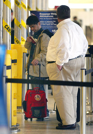 Passengers wait to board a flight.