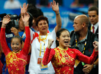 China celebrates its gold medal. Click image to expand.