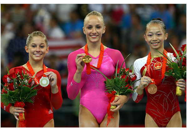 Silver medalist Shawn Johnson, gold medalist Nastia Liukin, and bronze medalist Yang Yillin of China.