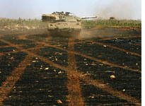 Israeli armored forces operate against Hezbollah gunmen. Click image to expand.